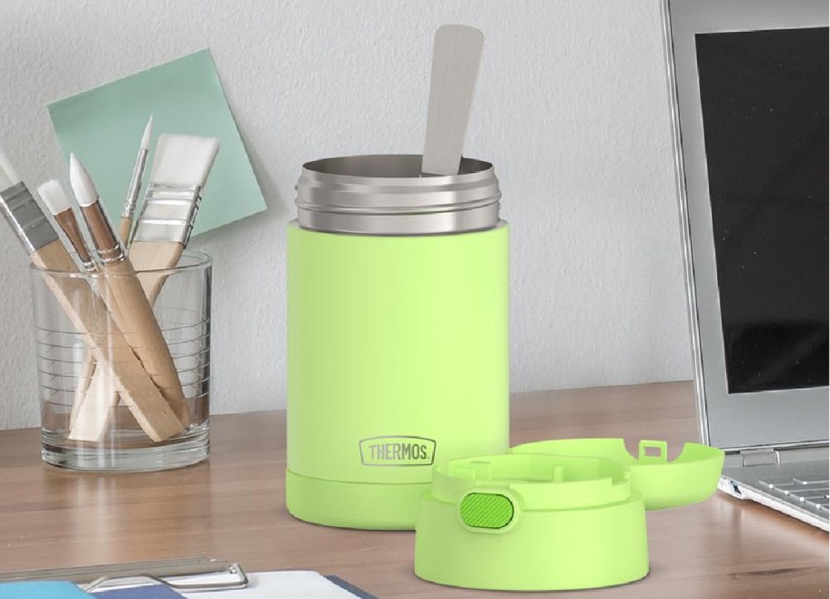 Lime green thermos displayed on top of a table