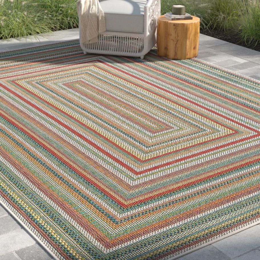a geometric rectagular rug on a patio