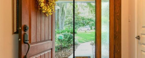 A front door of a home with a Magnetic Screen door