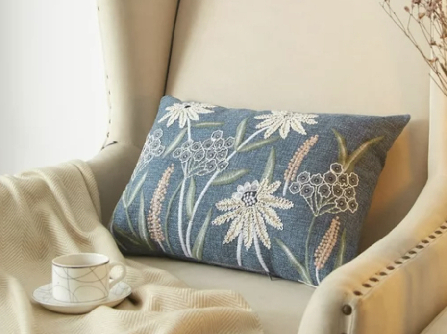 chambray floral pillow on cream accent chair