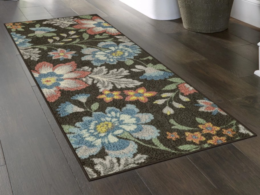 floral runner rug on dark wood floor