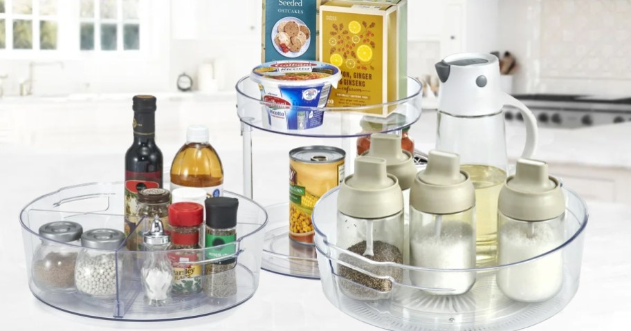 three clear acrylic turntable organizers on kitchen counter