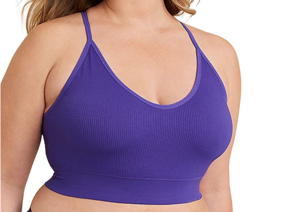 A woman wearing a purple sports bra