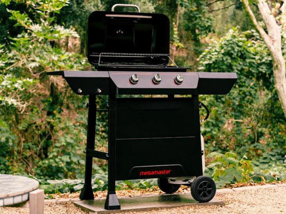 black 3-burner gas grill outside with lid open