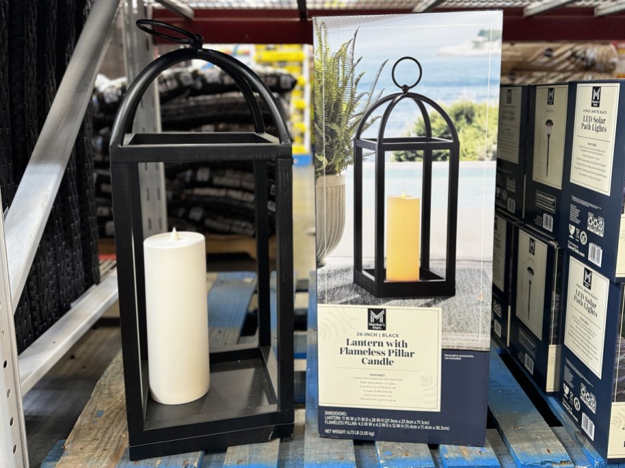 tall black lantern with flameless candle inside on display in store