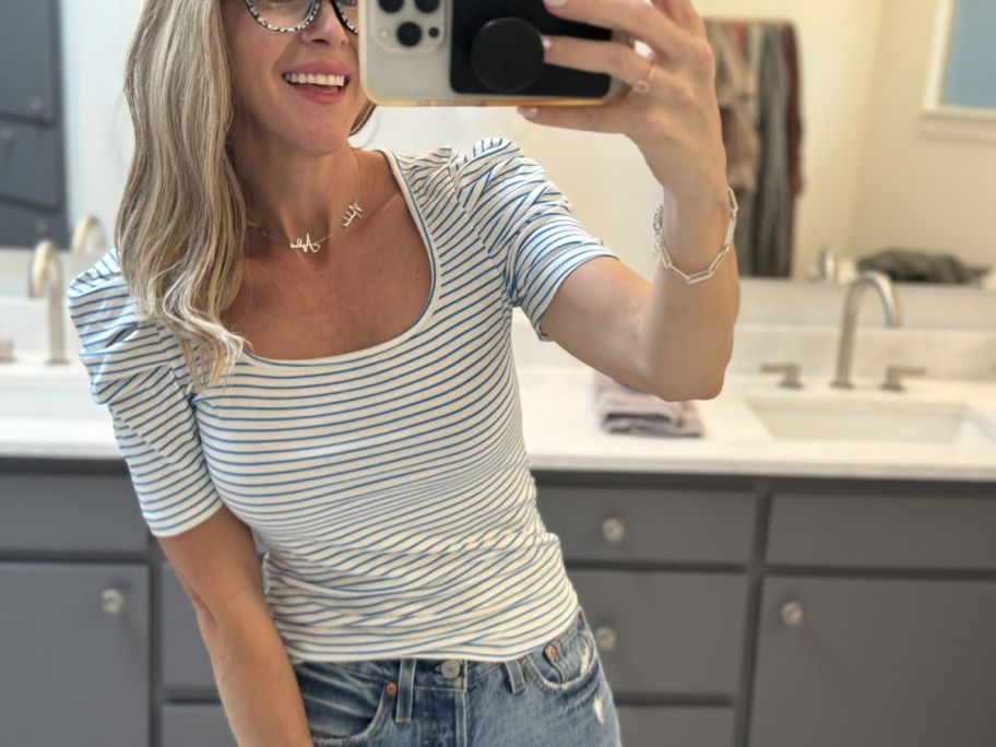 A woman wearing a Puff Sleeve Striped T-Shirt