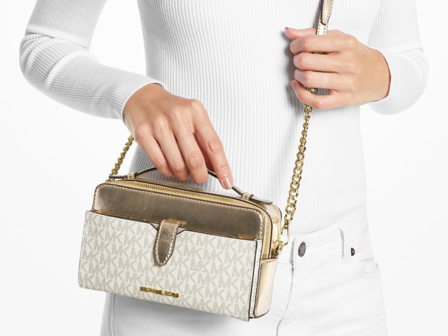 woman in white outfit with gold and white crossbody bag