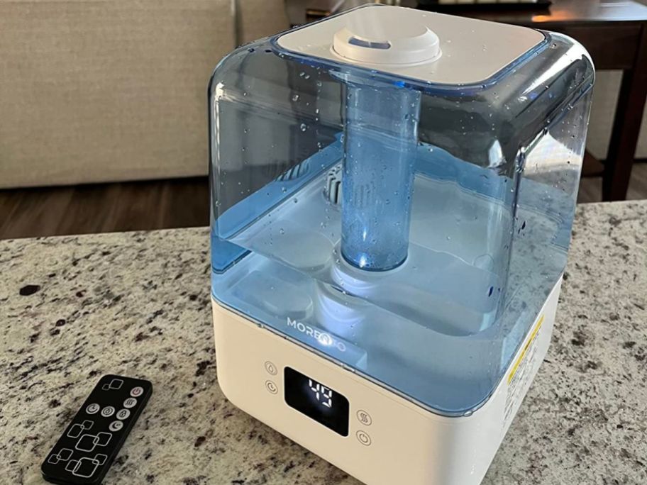 A Morento Humidifier on a counter next to the remote