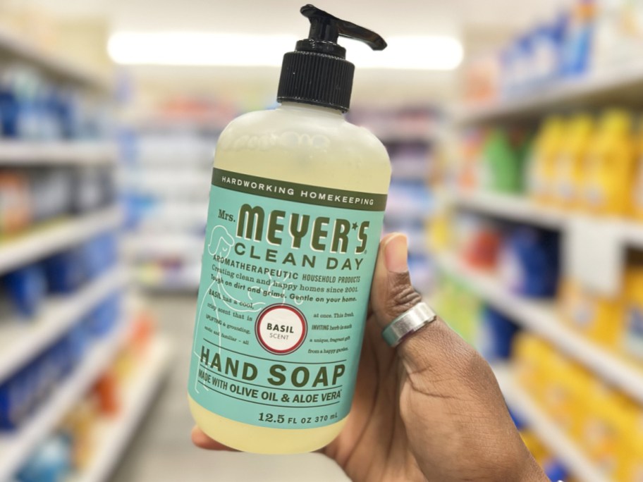 hand holding up a bottle of Mrs. Meyer's Hand Soap in Basil scent