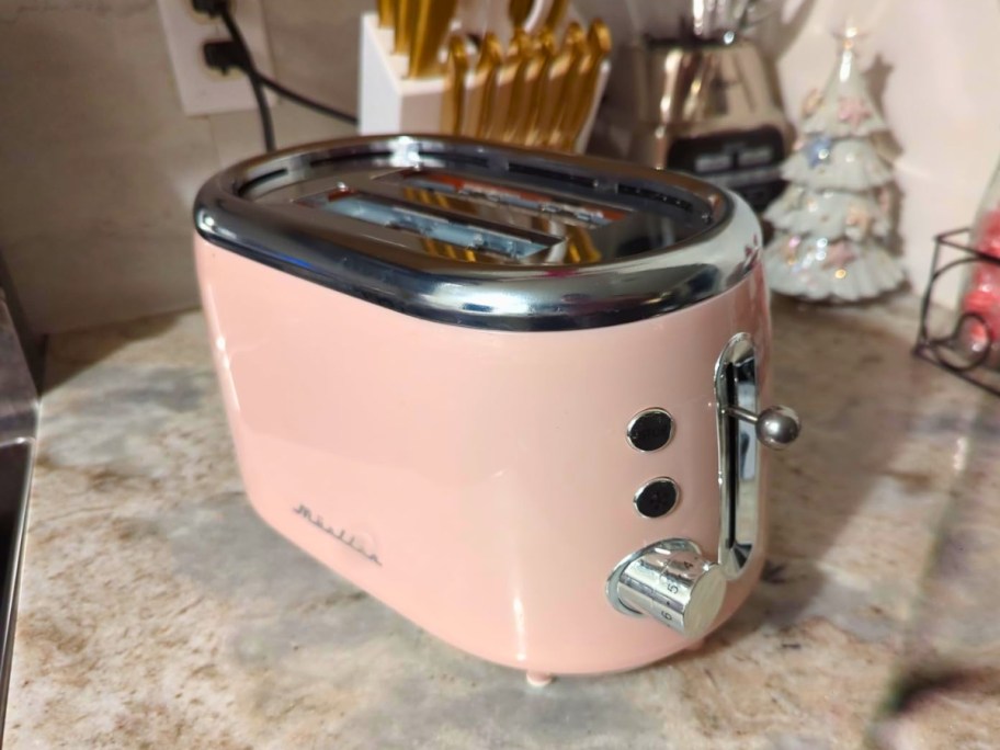 mueller retro 2-slice toaster in pink on kitchen counter
