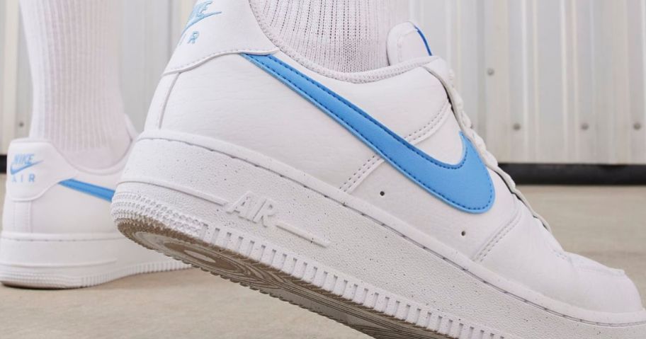 Feet wearing a pair of Nike Air Force One Shoes