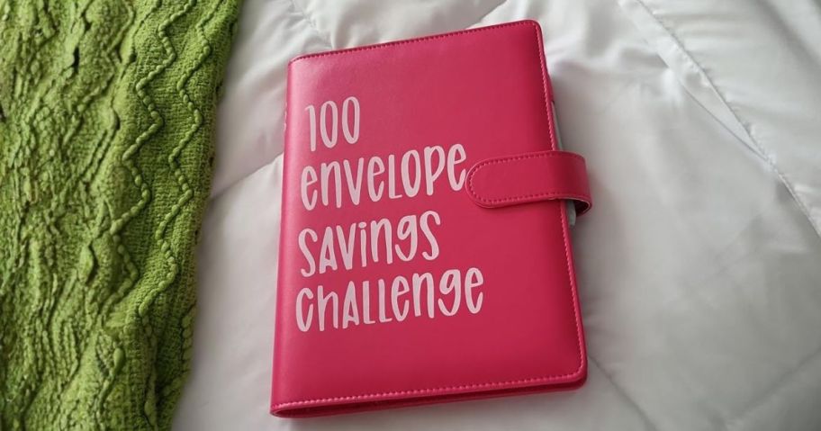 pink 100 Envelopes Money Saving Challenge Binder & Budget Planner on bed