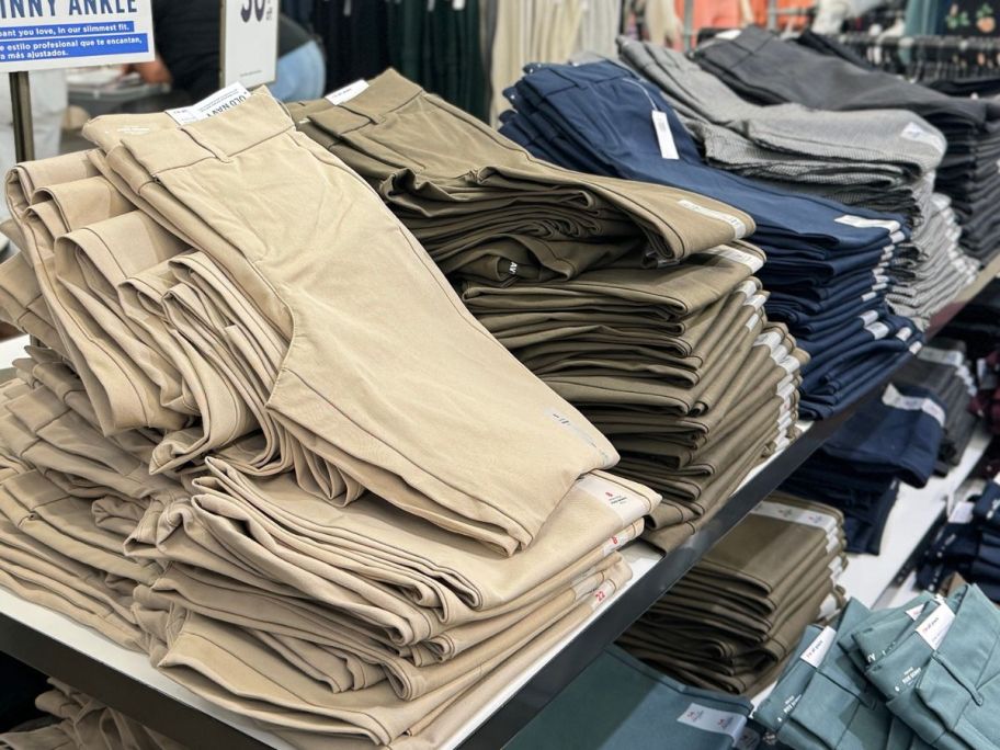 Stocks of folded Old Navy Women's Pants on a table at the store