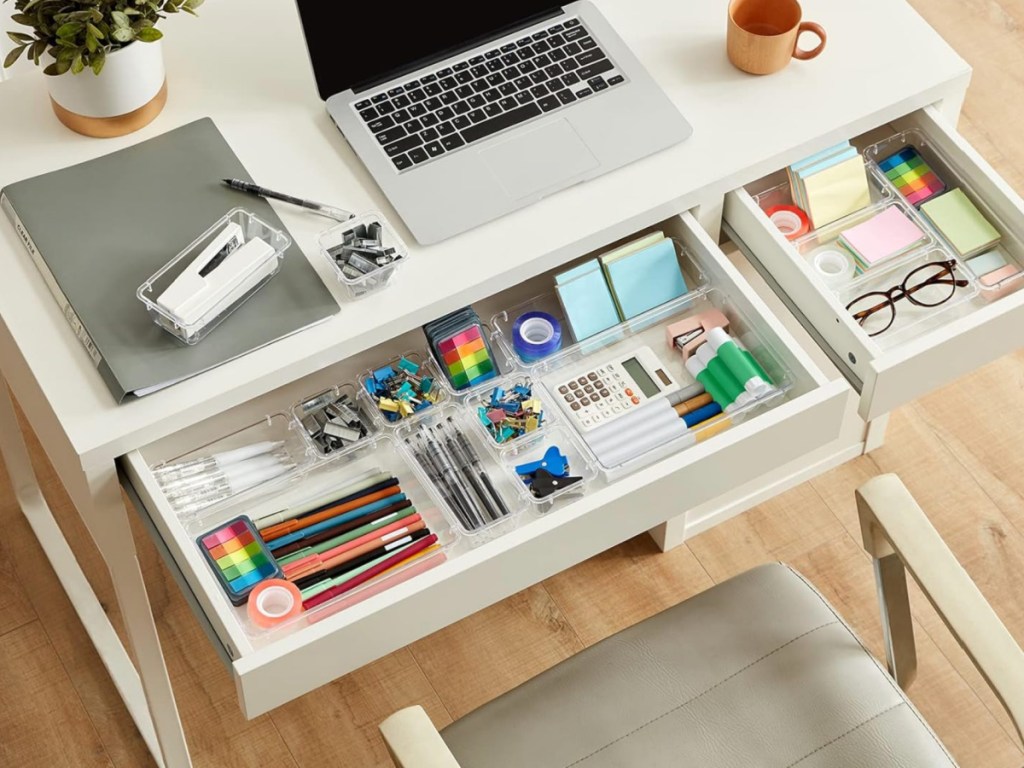 clear organizer holding office supplies in desk drawer