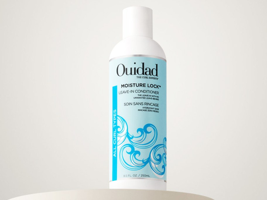 white and blue bottle of Ouidad Moisture Lock Leave-in Conditioner