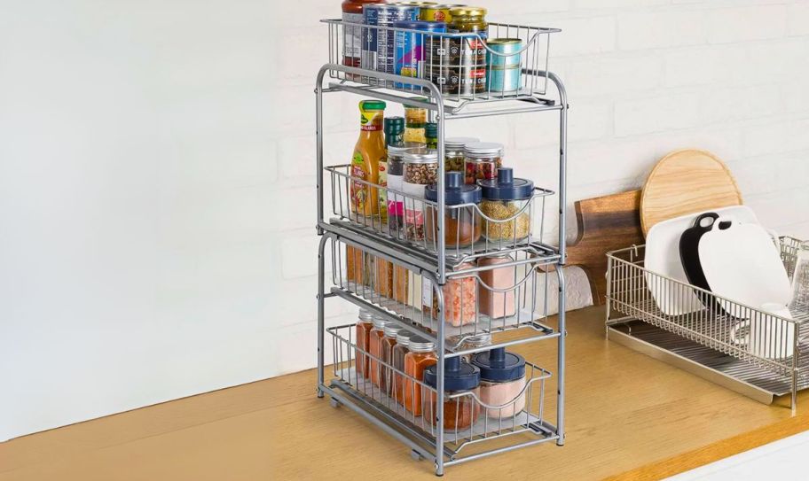 2 under cabinet sliding storage racks stacked atop each other and filled with food items