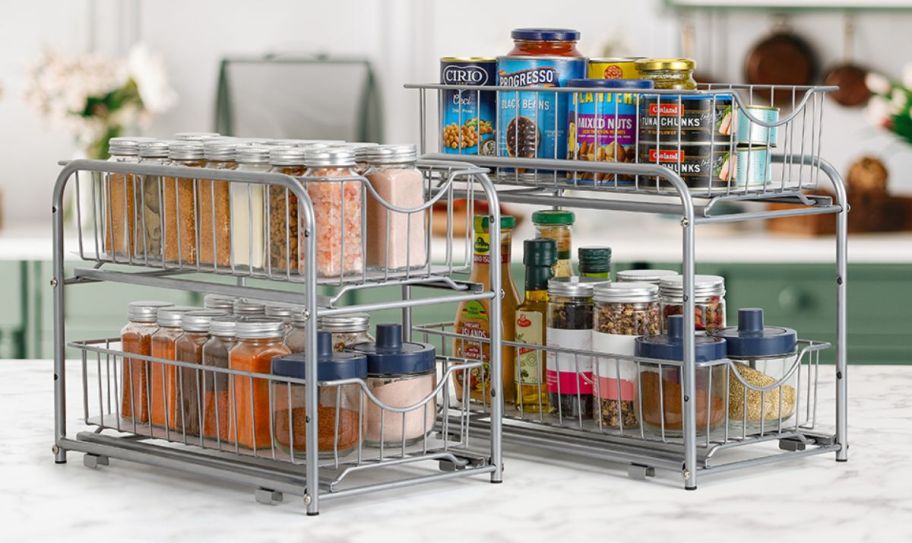 2 under cabinet sliding storage racks shown filled with food items