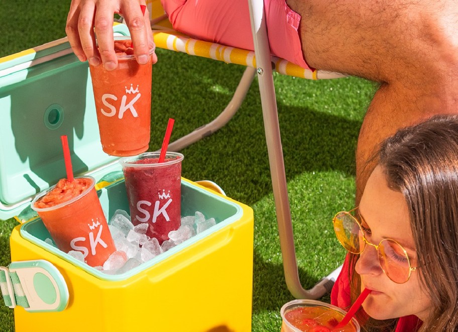 Person grabbing drink from SK from yellow cooler