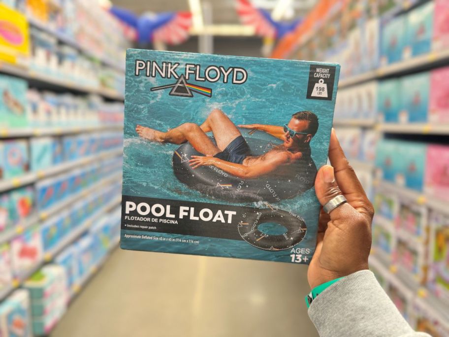 A hand holding a Pink Floyd 40 inch Inflatable Swim Tube