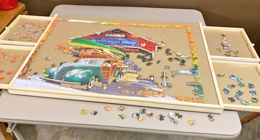 assembling a truck puzzle on a wood puzzle table with drawers