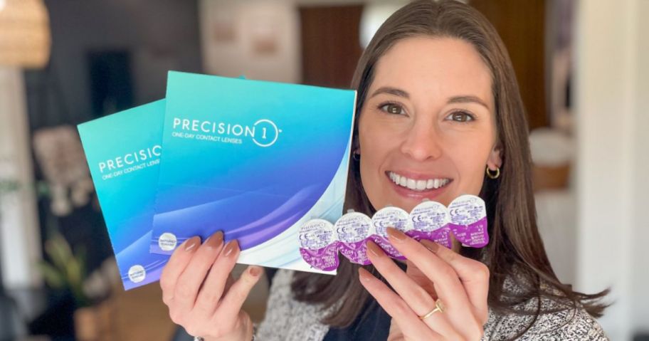 Woman holding 2 boxes of Alcon Contact Lenses