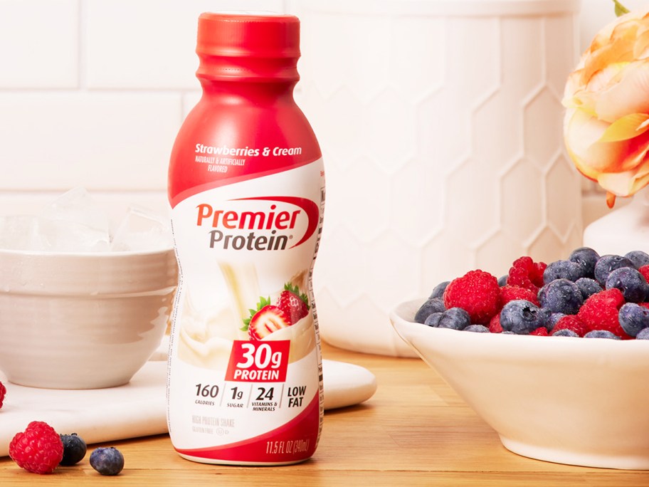 bottle of Premier Protein on counter near bowl of berries