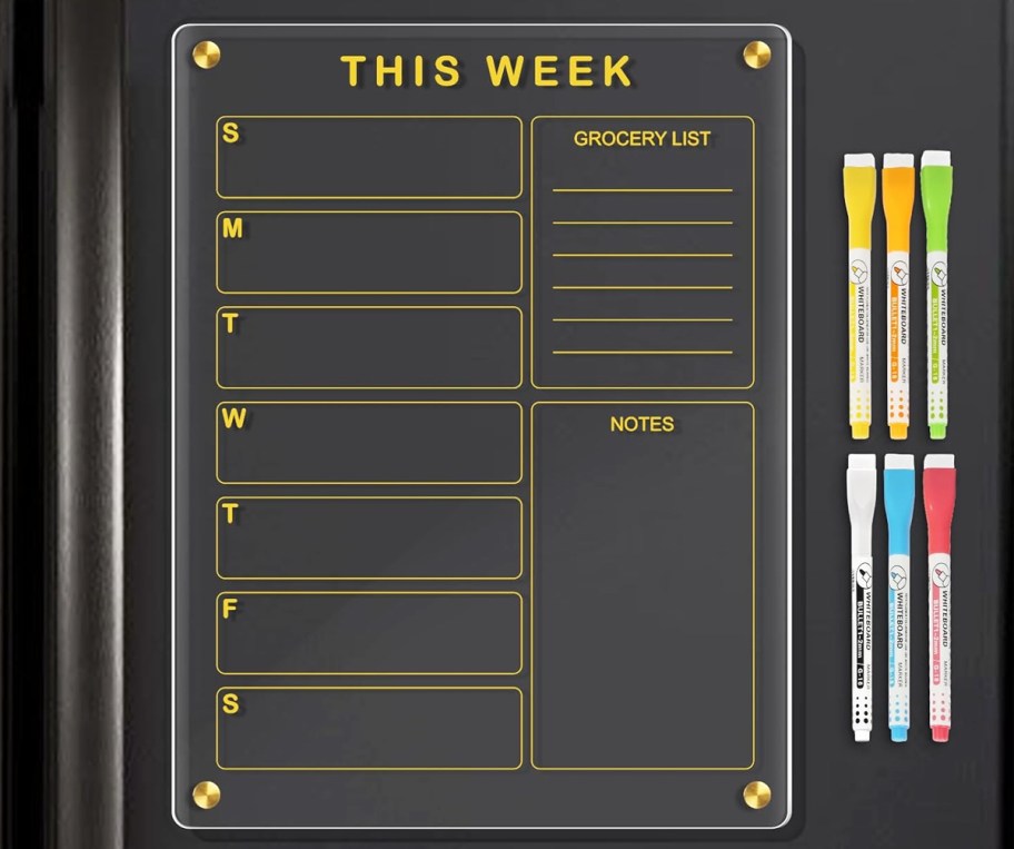 weekly planner on black fridge with chalk markers