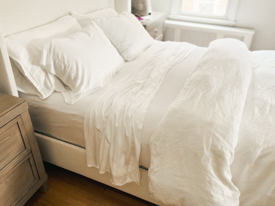 bed made with white sheets and comforter