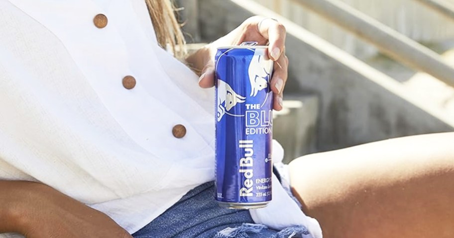 woman holding can of Red Bull Blue Edition Blueberry Energy Drink