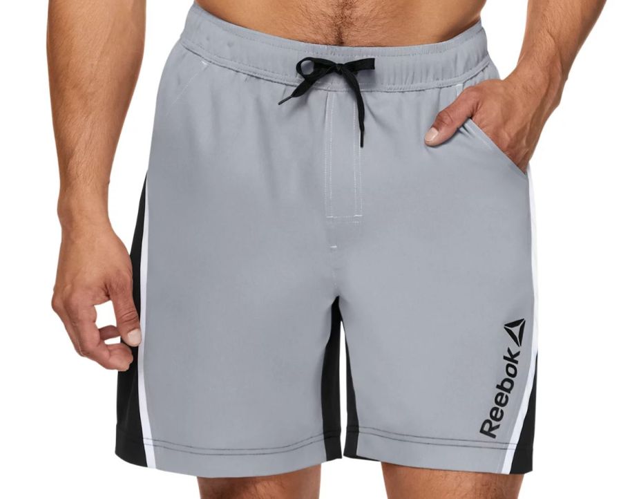 a man wearing a pair of gray swim trunks