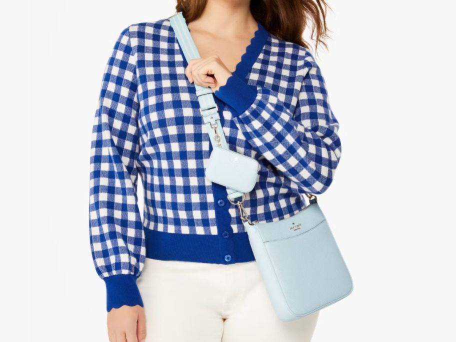 A woman wearing a Kate Spade Rosie North South Swingpack Crossbody