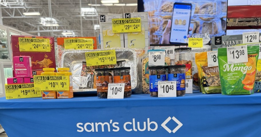 table full of items on sale at sam's club with scan & go