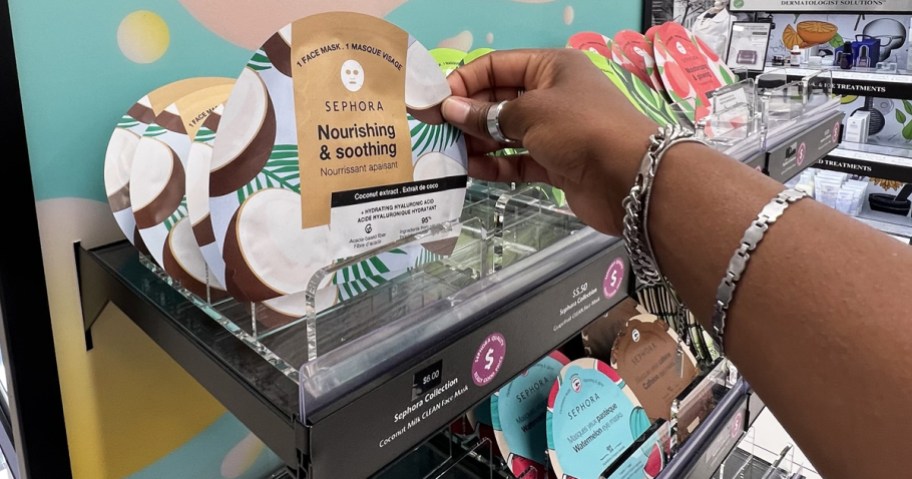 hand grabbing a coconut sheet mask from store display