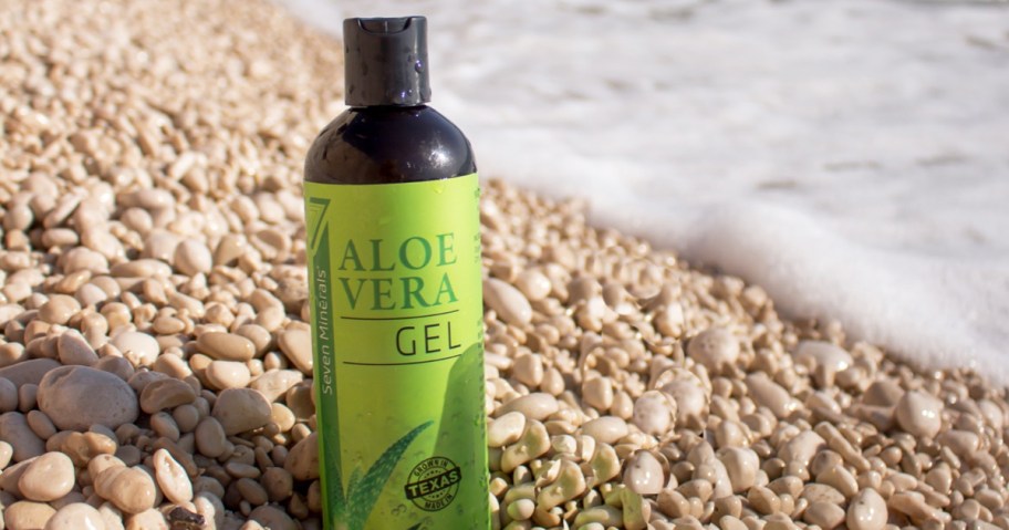 bottle of Seven Minerals Organic Aloe Vera Gel on rocky beach near water
