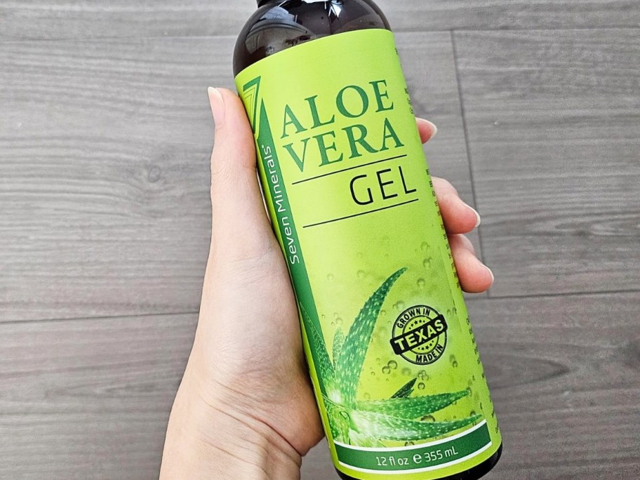 hand holding a bottle of Seven Minerals Organic Aloe Vera Gel