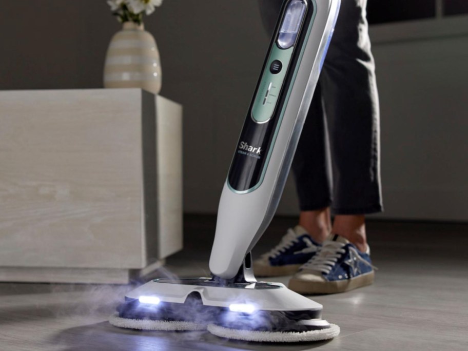 person cleaning floor with shark steam and mop