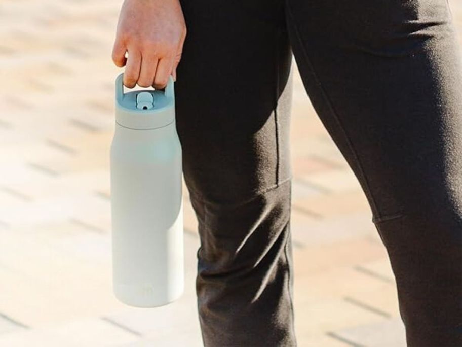 person holding Simple Modern 34oz Water Bottle w/ Straw Lid