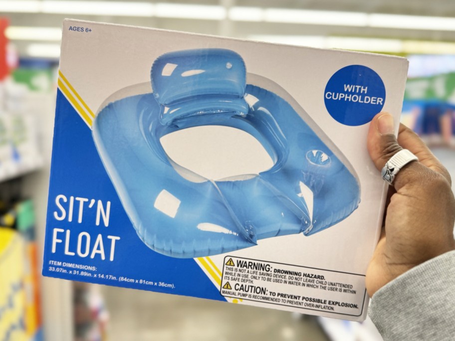 hand holding up a blue inflatable pool float
