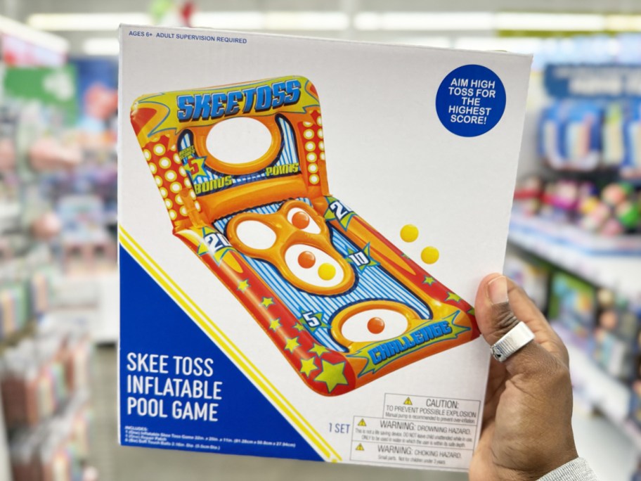 hand holding up box for an orange Skee Toss Inflatable Pool Game