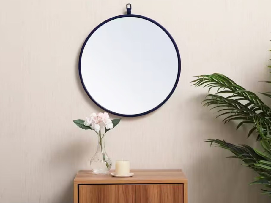 round mirror hanging on a wall
