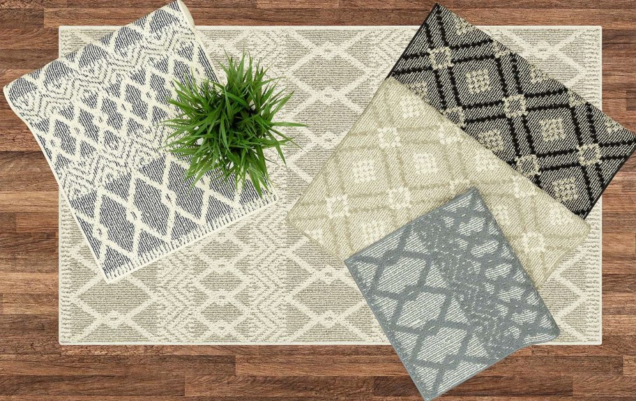 multiple printed area rugs on a wood floor