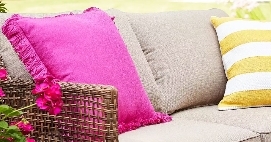 pink pillow with fringe edges on outdoor couch