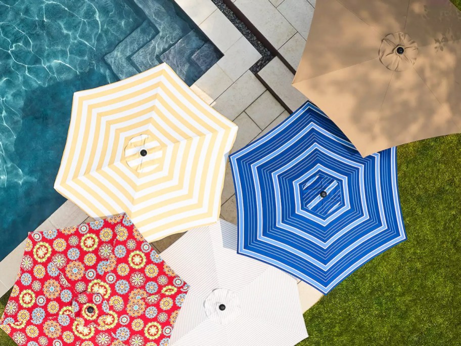 multiple opened patio umbrellas near pool