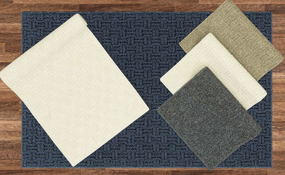 multiple colors of weave print area rugs on a wood floor