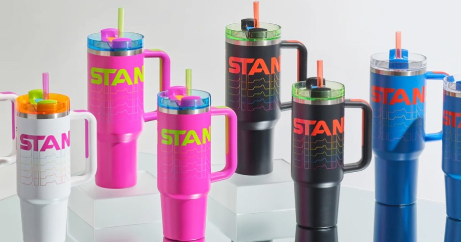 white, pink, black, and blue stanley tumblers