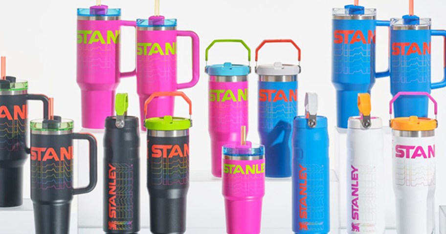 white, pink, black, and blue stanley tumblers and bottles