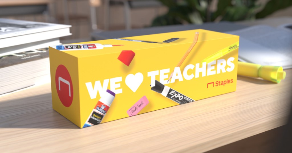 yellow box filled with school supplies that says "we love teachers" on outside on desk