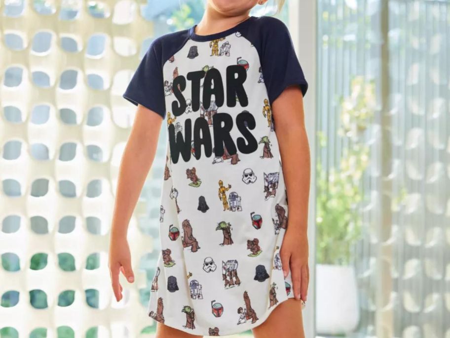 Little girl wearing a star wars sleep shirt
