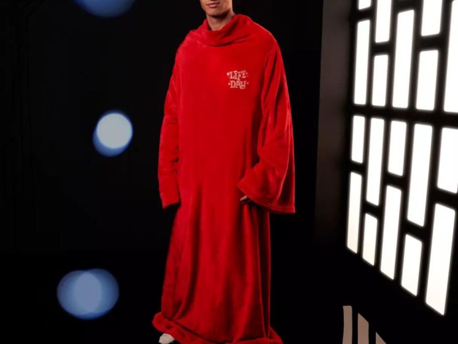 Man wearing a adult Star Wars Lfife Day throw blanket with sleaves