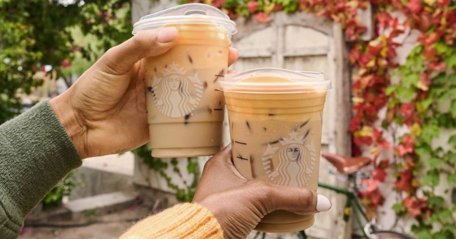 hand each holding up a Starbucks drink